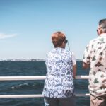 two seniors standing on a cruise ship